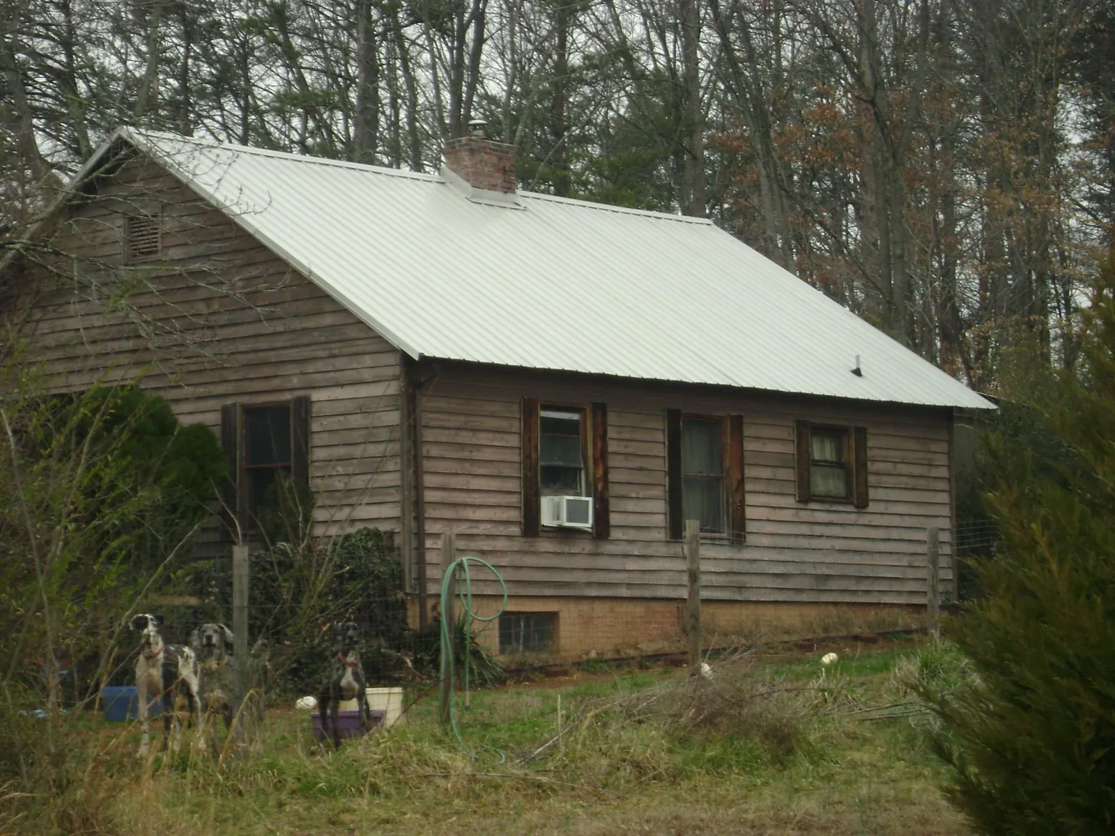 White metal roof on an old wood sided farmhouse, from a Metal Roof Installation job in Millbrae
